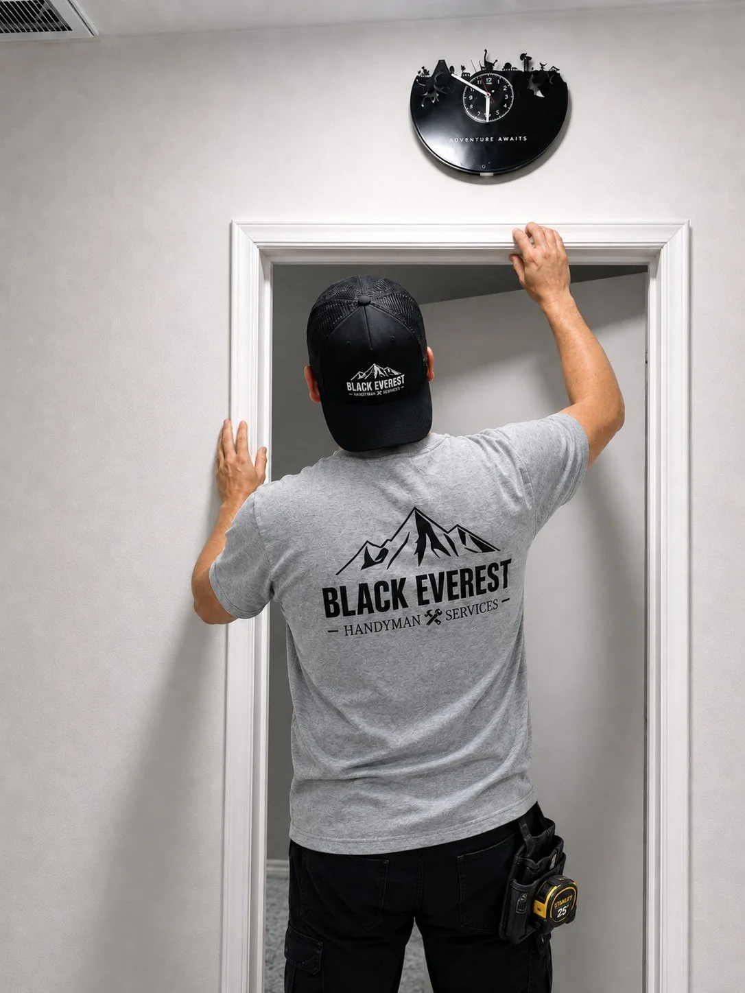 Black Everest handyman working on a door frame