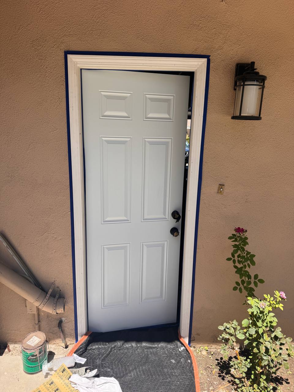 Entry door prepared for refinishing and trim painting