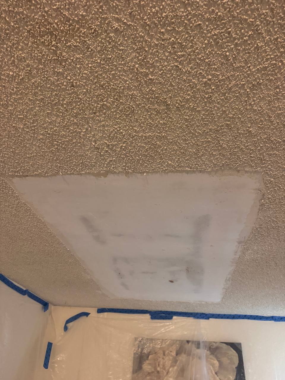 Ceiling drywall patch prepared for texture matching