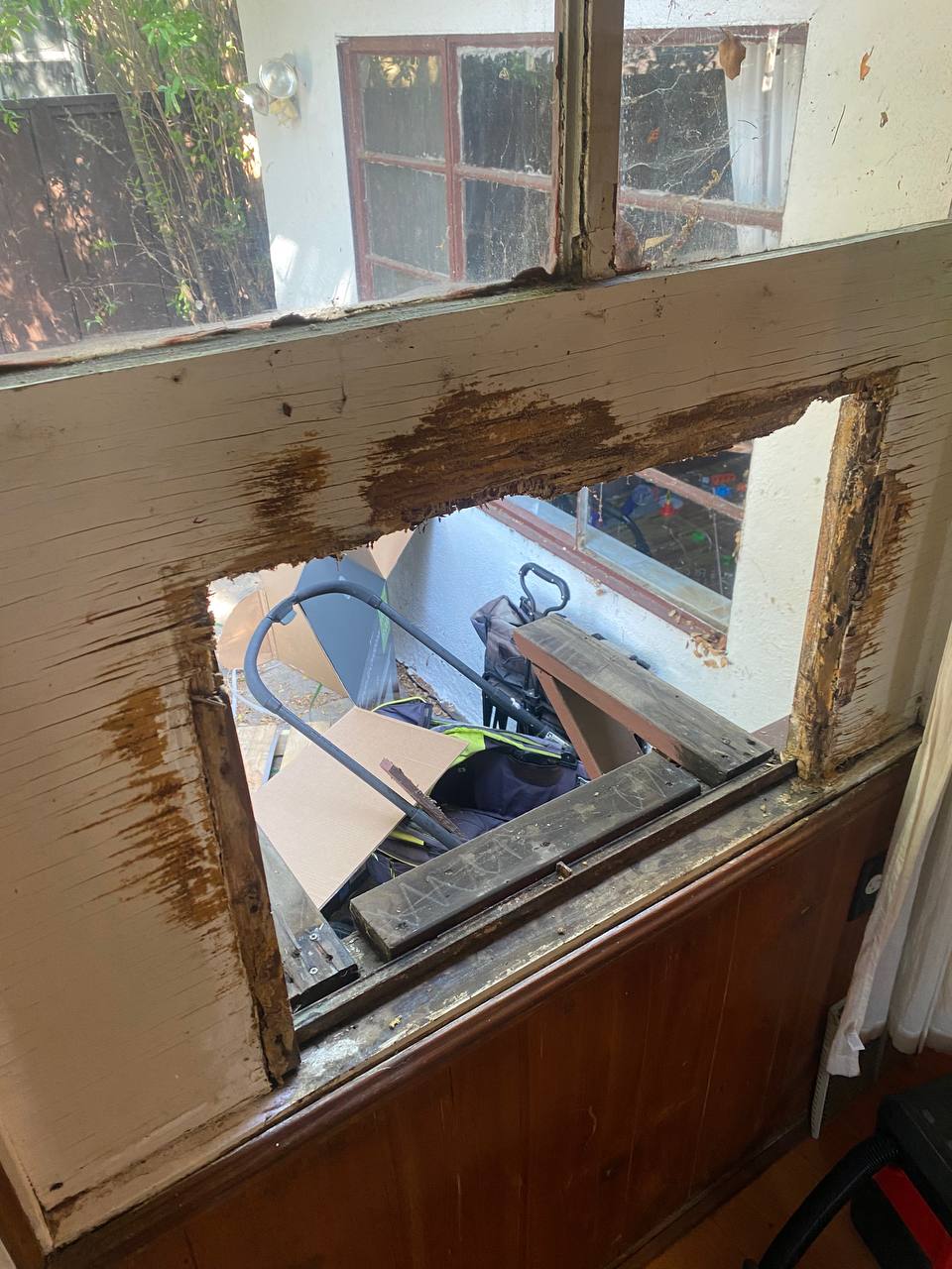 Damaged wooden window frame before replacement